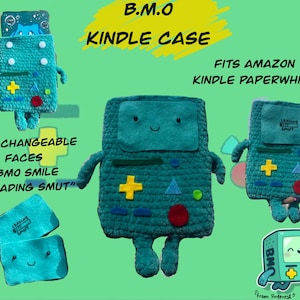 May include: Teal crochet Kindle case with a BMO design, featuring a smiling face and a loading screen. Includes a yellow plus sign, red circle, and blue triangles. Fits Amazon Kindle Paperwhite. Text: B.M.O KINDLE CASE, WITH CHANGEABLE FACES -BMO SMILE -"LOADING SMUT".