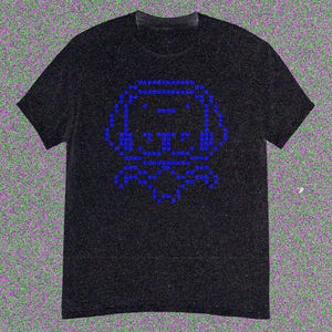 May include: Black t-shirt with a blue pixelated dog design. The dog's image is formed from small blue squares, creating a retro digital look. The shirt has a crew neck and short sleeves.