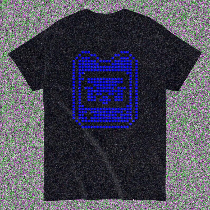 May include: Black t-shirt featuring a blue pixelated graphic of a handheld gaming device. The design is centered on the front. The shirt is made of a soft material.