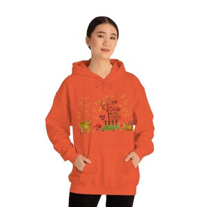 May include: Orange hoodie with a fall-themed design featuring a tree, leaves, and the text "Fall is for falling leaves".
