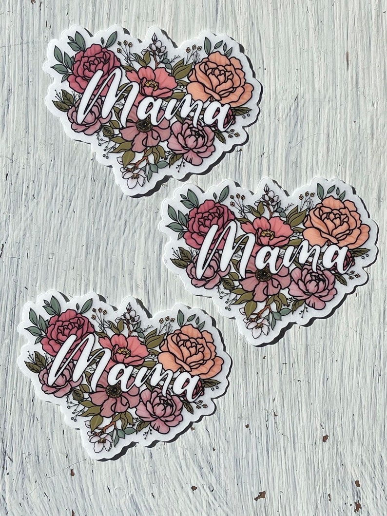 May include: Three floral heart stickers with the word "Mama" written in white cursive lettering. The flowers are pink, peach, and white.