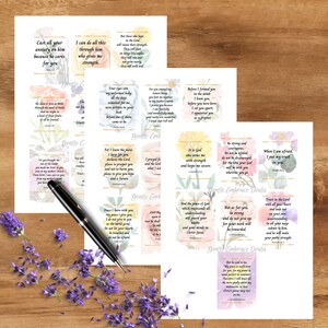 May include: Several printed cards with inspirational quotes and floral designs are arranged on a wooden surface, alongside a pen and lavender sprigs. The cards feature text from the Bible. The words "Gentle Embrace Doula" are also visible.