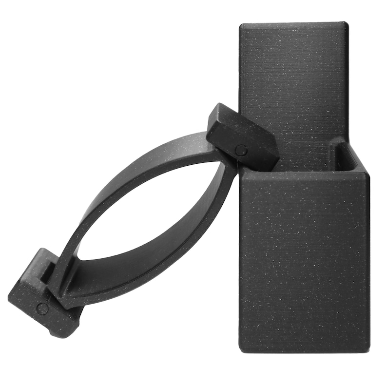 May include: Black plastic bike mount with a clip to hold a light or other device. The mount has a textured finish.