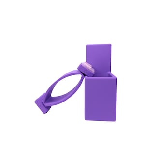 May include: A purple plastic phone holder with a built-in stand and a clip to hold the phone in place.