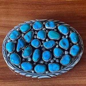 Sterling silver and 24 Turquoise Navajo belt buckle.