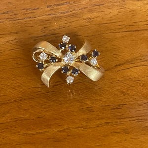 18Kt diamonds and sapphires bow pin includes GAL Appraisal image 1