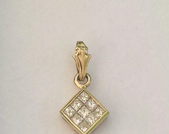 May include: A gold pendant featuring a square-shaped setting filled with nine small, clear, square-cut stones arranged in a grid pattern. The pendant includes a polished gold bail at the top for attachment, showcasing a metallic finish and clear stones.