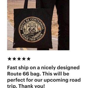 May include: Black tote bag featuring a Route 66 Centennial design with a vintage car graphic. The bag includes the text "Route 66 Road Trip Club" and the years 1926-2026.