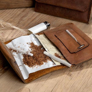 Open look of the crazy brown leather tobacco pouch on the table.