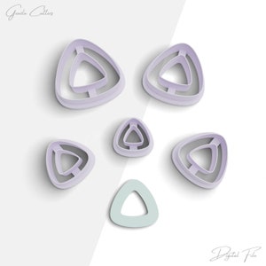 May include: Set of six purple triangle cookie cutters, with a smaller green triangle cutter in the center.  The cutters are arranged in a star shape.
