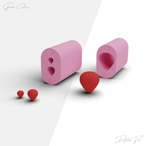 May include: A set of three pink silicone molds for making heart-shaped candies or chocolates. The molds are shown with red heart-shaped candies.