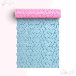 May include: A light blue silicone rolling pin with a star pattern. The rolling pin is rolled up and the pattern is visible on the surface.