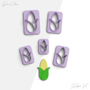 May include: Set of five purple plastic cookie cutters shaped like corn on the cob. The cutters are arranged on a white background. There is also a single yellow and green corn on the cob cookie cutter in the centre of the image.