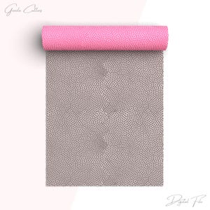 May include: A rolled-up pink mat with a textured surface, partially unrolled to reveal a grey dotted pattern. The words "Greeda Cutters" and "Digital File" are written in cursive.