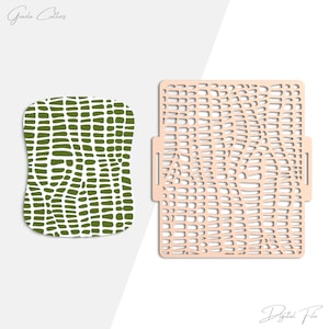 May include: Two craft stencils. One is a green, organic-shaped stencil with a pattern of dark green shapes on a white background. The other is a square, light-colored stencil with a cut-out pattern.