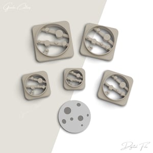 May include: Set of six cookie cutters in the shape of planets and a moon. The cutters are made of beige plastic and are arranged on a white background. The text "Digital File" is visible in the bottom right corner of the image.