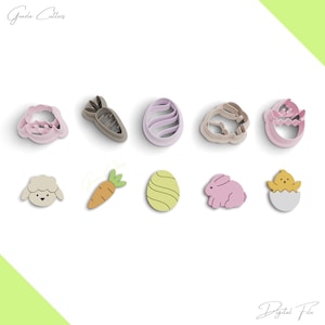 May include: A set of nine Easter-themed cookie cutters. The cutters are made of plastic and feature various designs, including a bunny, a chick, a carrot, an egg, and a lamb. The cutters are pink, purple, brown, and yellow.