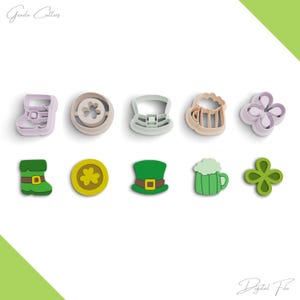 May include: Set of ten cookie cutters in various shapes, including a shamrock, a beer mug, a leprechaun hat, a boot, and a coin. The cutters are made of a light green, light blue, and light pink plastic.