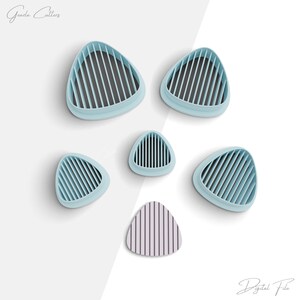 May include: Five light blue triangle-shaped cookie cutters with a grid pattern and one smaller light purple triangle-shaped cookie cutter with a grid pattern. The text "Gazda Cutters" is in the top left corner of the image. The text "Digital File" is in the bottom right corner of the image.