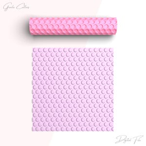 May include: A pink rolling pin with a hexagonal pattern. The rolling pin is on a white background. Digital File.