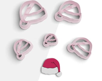 May include: Five pink plastic cookie cutters shaped like Santa hats, and one red and white Santa hat cookie cutter.