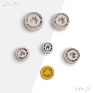 May include: Set of five cookie cutters in various sizes, featuring a four-leaf clover design. The cutters are made of white plastic and are arranged on a white background. The text "Digital File" is visible in the bottom right corner of the image.