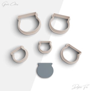 May include: Set of six cookie cutters in the shape of cauldrons. The cutters are made of white plastic and are arranged in a circle on a white background. The largest cutter is in the center of the circle, and the smallest cutter is on the outside of the circle. The cutters are all the same shape, but they are different sizes. The smallest cutter is about 1 inch in diameter, and the largest cutter is about 3 inches in diameter.