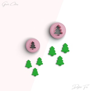 May include: Two pink plastic Christmas tree cookie cutters, one larger than the other, and five green plastic Christmas tree cookie cutters.  The cutters are on a white and pink background.  The text "Digital File" is at the bottom of the image.