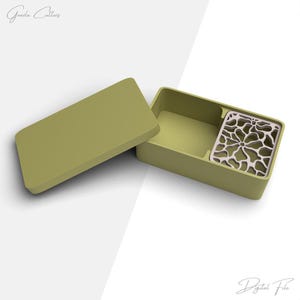 May include: An open, olive-green rectangular box with a matching lid. Inside, a decorative, off-white, floral-patterned insert sits in the corner. The text "Gooda Cutters" and "Digital File" are visible.