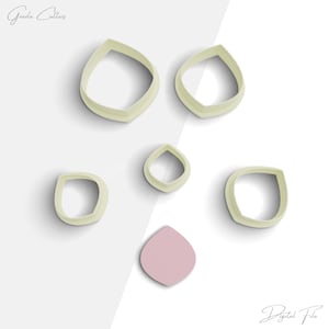 May include: Set of six white plastic cookie cutters shaped like flower petals. The cutters are arranged on a white and gray background. The text "Digital File" is at the bottom of the image.