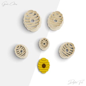 May include: Five cookie cutters shaped like honeycombs, in various sizes, and one cookie cutter shaped like a beehive. The beehive cookie cutter is yellow with a brown entrance.