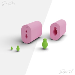 May include: Pink silicone mold with three impressions of a small bottle shape. The mold is shown next to three green bottles made with the mold.
