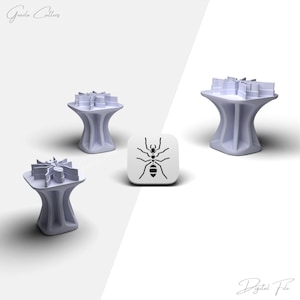 May include: Four light purple cookie cutters with a unique design, along with a white square with a black ant graphic. The cutters have a flower-like shape. The text "Grazia Cutters" and "Digital File" are visible.