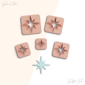 May include: A collection of star-shaped cookie cutters in various sizes. The cutters are a light pink color and are set on a white background. One light blue star is also included. The words "Grazila Cutters" and "Digital File" are written in cursive.
