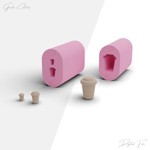 May include: Two pink silicone molds for making small coffee cup shaped candies. The molds are open and show the inside of the molds. There are three small brown coffee cups made with the molds.