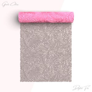 May include: A pink rolling pin with a palm leaf pattern is unrolled onto a surface, revealing a detailed leaf design. The rolling pin is labeled "Grada Cutters" and "Digital File".