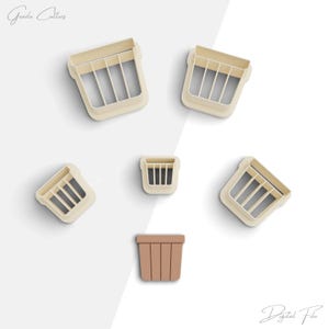 May include: Set of six cookie cutters in the shape of flower pots. The cutters are made of white plastic and have a smooth finish. The largest cutter is 3 inches wide and the smallest is 1 inch wide. The cutters are arranged in a circle on a white background.