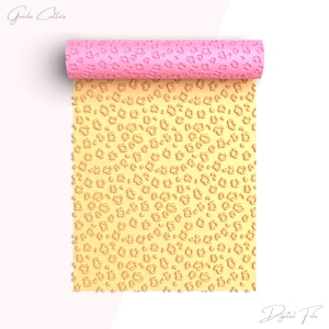 May include: A yellow and pink silicone rolling pin with a leopard print design. The rolling pin is unrolled and the design is visible on the surface.