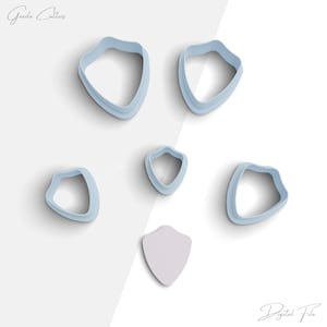 May include: Set of six blue plastic cookie cutters shaped like shields. The cutters are arranged on a white background. The word "Digital File" is written in black at the bottom of the image.