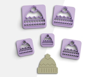 May include: Five purple plastic cookie cutters shaped like winter hats with a white pom-pom on top. A single brown plastic cookie cutter shaped like a winter hat is also shown.