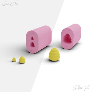May include: Pink silicone mold with two cavities shaped like a beehive. The mold is shown next to three yellow beehive-shaped objects.
