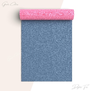 May include: A roll of blue and pink patterned wrapping paper. The paper has a textured, woven look. The roll is partially unrolled, revealing the blue side of the paper.