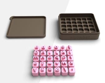 May include: A set of pink alphabet letter cutters with a brown storage box and lid. The box is labeled "alphabet". The letters are arranged in a grid, ready for use in crafting or baking projects. The image is set against a white background.