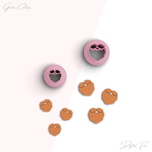 May include: Pink cookie cutters in the shape of a face and several orange cookie cutouts of a beard. The image has the text "Greeda Cutters" and "Digital File" in the corners.