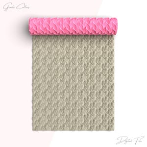 May include: A pink silicone rolling pin with a leaf pattern. The rolling pin is rolled out on a beige surface with a leaf pattern.