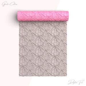 May include: A rolled pink textured material with a gray, patterned sheet unrolled below. The pattern on the sheet is a repeating, organic design. The words "Grada Cutters" and "Digital File" are in the image.