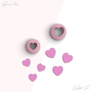 May include: A set of pink heart-shaped cookie cutters, with two larger cutters and six smaller cutters. The cutters are arranged on a white and pink background. The text "Gouda Cutters" is in the top left corner of the image. The text "Digital File" is in the bottom right corner of the image.