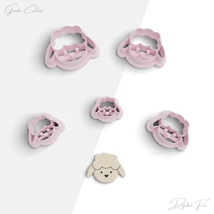 May include: Set of six pink plastic cookie cutters shaped like sheep. The cutters are in various sizes and feature a simple sheep design with a heart-shaped face.