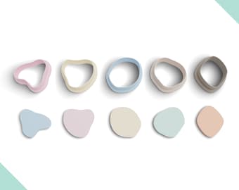 May include: A set of 10 cookie cutters in various shapes and colors. The cutters include a heart, a circle, a teardrop, a rounded rectangle, and a freeform shape. The cutters are arranged in two rows on a white background.