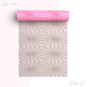 May include: A pink rolling pin with a starburst pattern. The rolling pin is rolled out on a white surface with a matching starburst pattern.